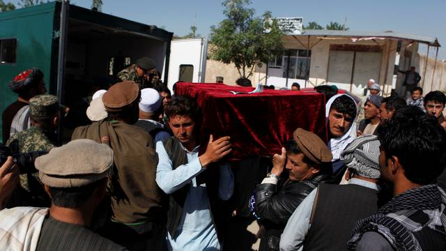 Relatives carry the coffin of one of the victims a day after an attack on an army headquarters in Mazar-i-Sharif