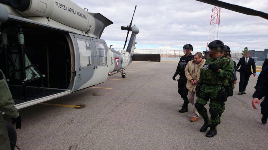 Mexico's top drug lord Joaquin "El Chapo" Guzman is escorted by soldiers in Ciudad Juarez, Mexico, as he is extradited to New York