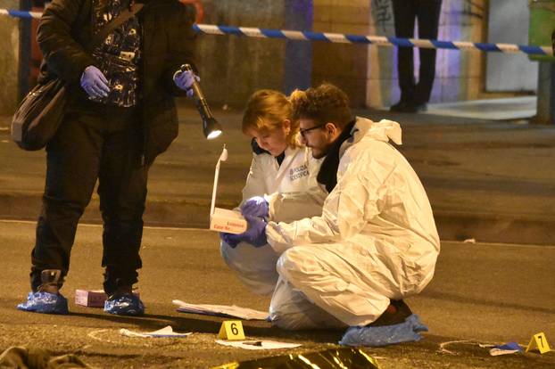 Italian Police officers work next to the body of Anis Amri, the suspect in the Berlin Christmas market truck attack, in a suburb of the northern Italian city of Milan