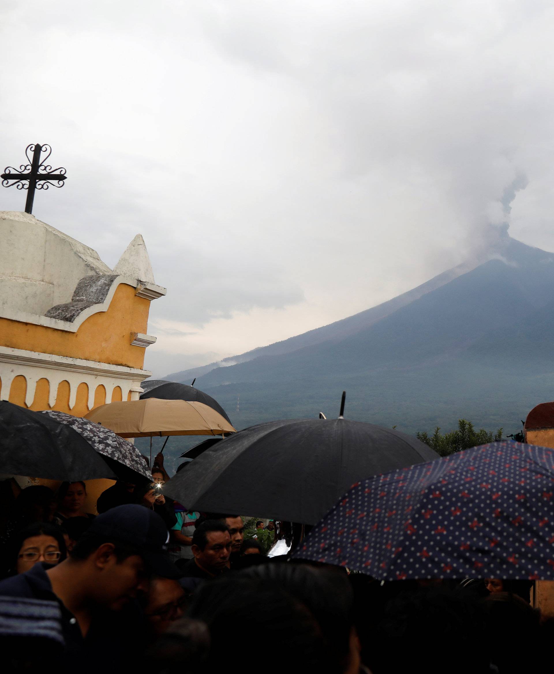 Mourners and relatives participate in the funeral of Juan Fernando Galindo, member of the National Coordinator for Disasters Reduction (CONRED), in Alotenango