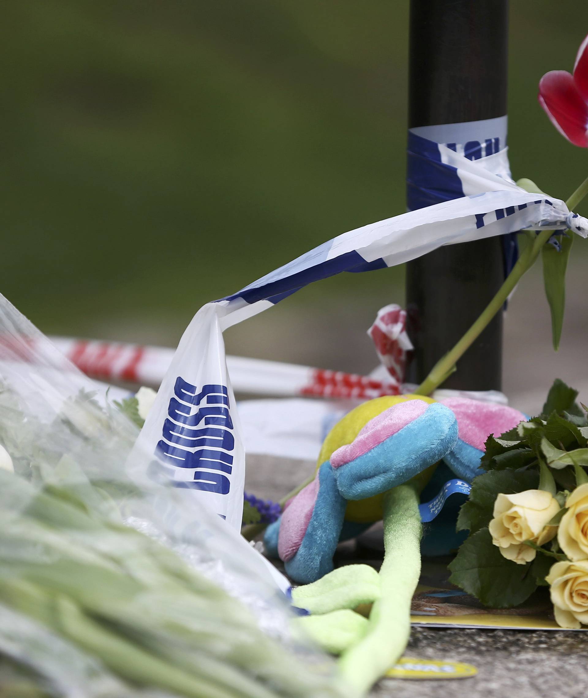 Flowers and messages are left near the scene of an attack by a man driving a car and weilding a knife left five people dead and dozens injured, in London