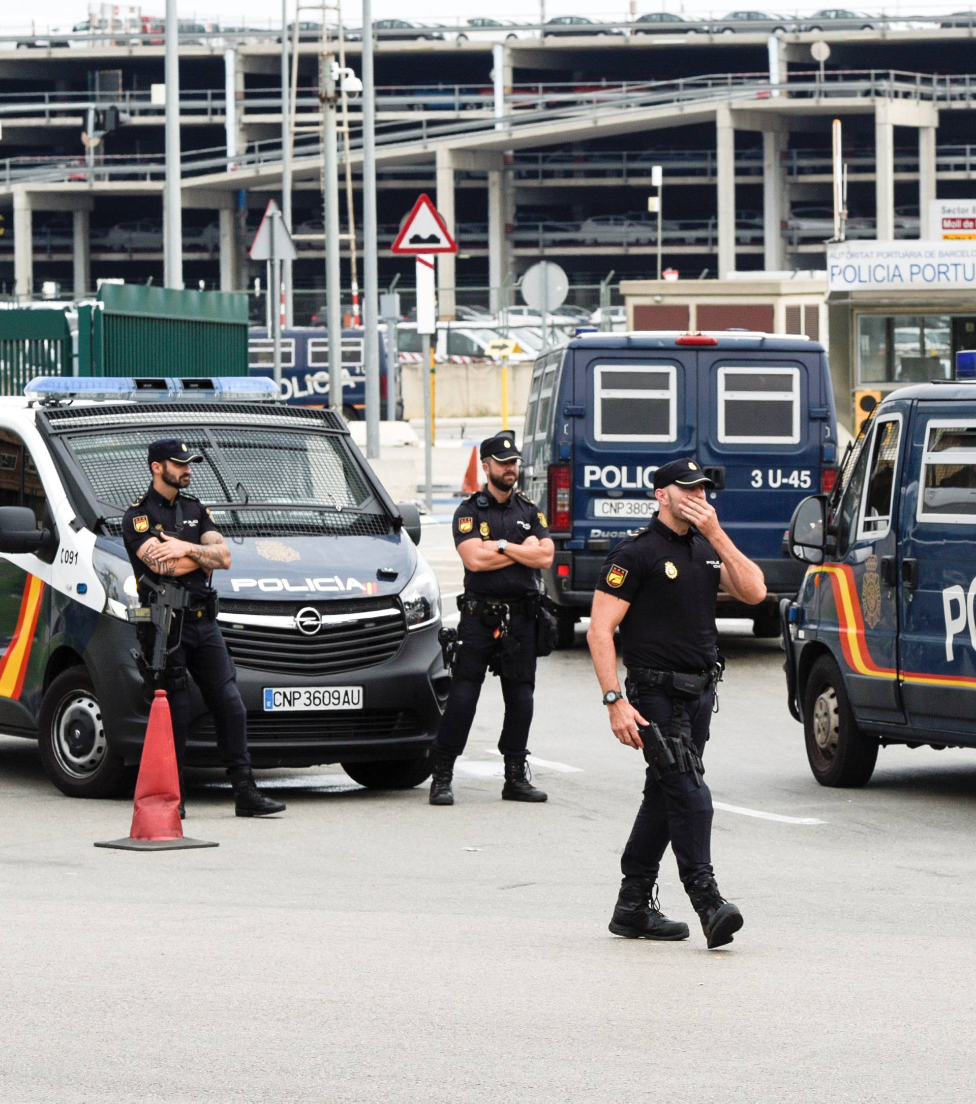 Spanish national police vehicles enter the port where hundreds of Spanish national police and civil guard reinforcements are housed in two ferries a day before the banned October 1 independence referendum, in Barcelona