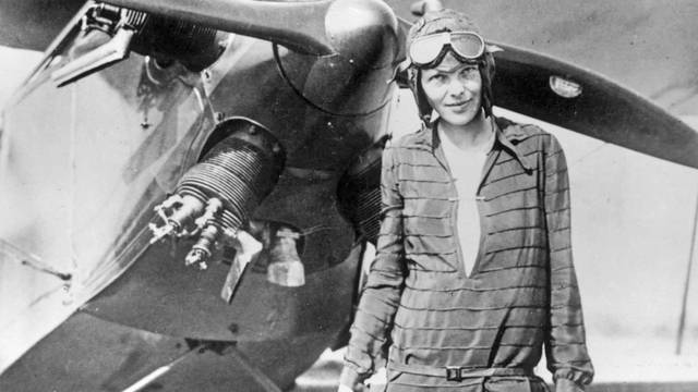 AMELIA EARHART (1897-1937) Pioneer American aviator in Newfoundland with her bi-plane "Friendship" in June 1928 prior to her record breaking flight across the America and back again.