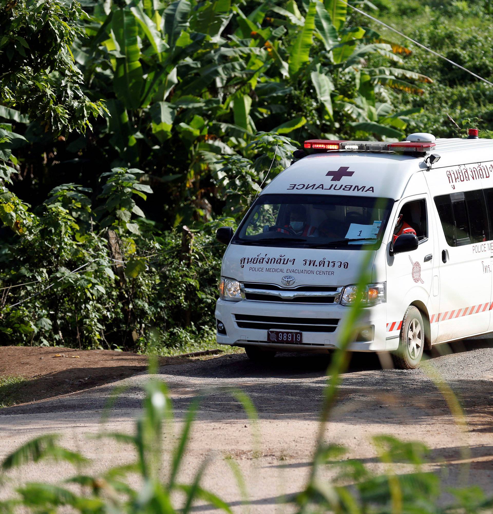 An ambulance believed to be carrying rescued schoolboys leaves from Tham Luang cave complex in the northern province of Chiang Rai