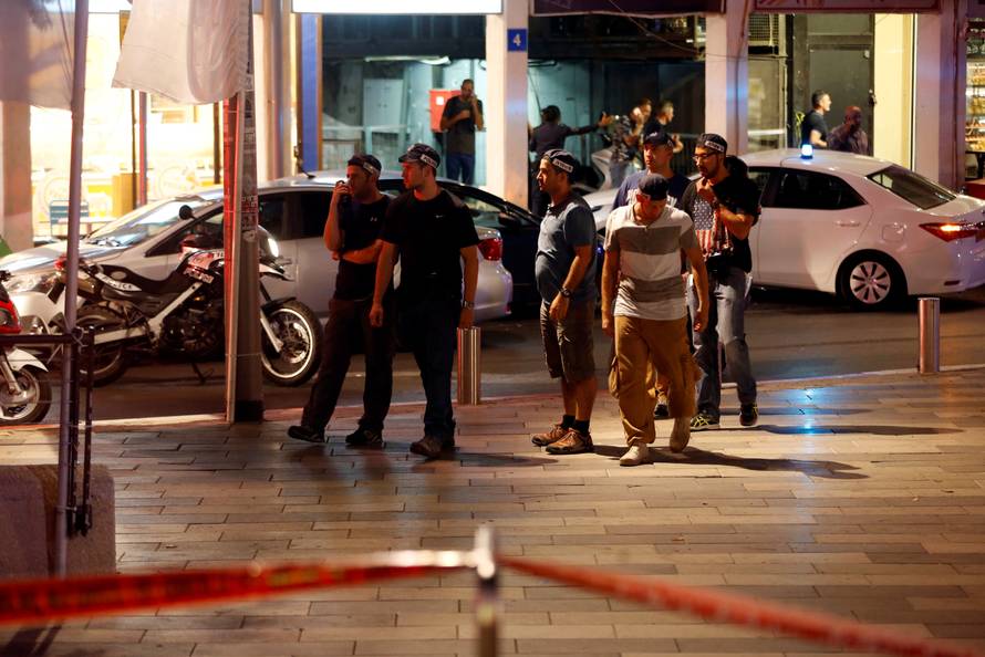 Israeli security personnel secure the area where a shooting attack took place in the center of Tel Aviv