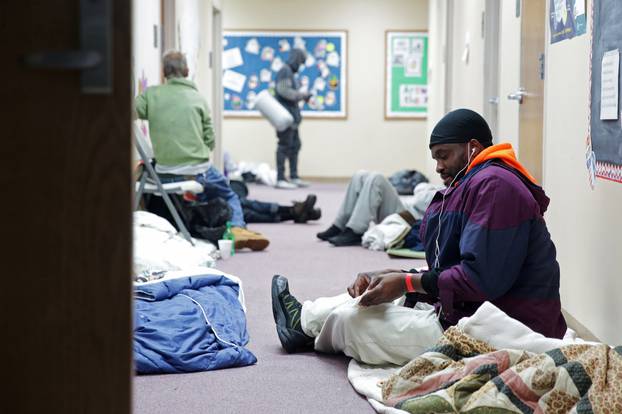 People take shelter at a Salvation Army facility after winter weather caused electricity blackouts in Plano.