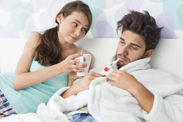 Young woman giving coffee mug to man