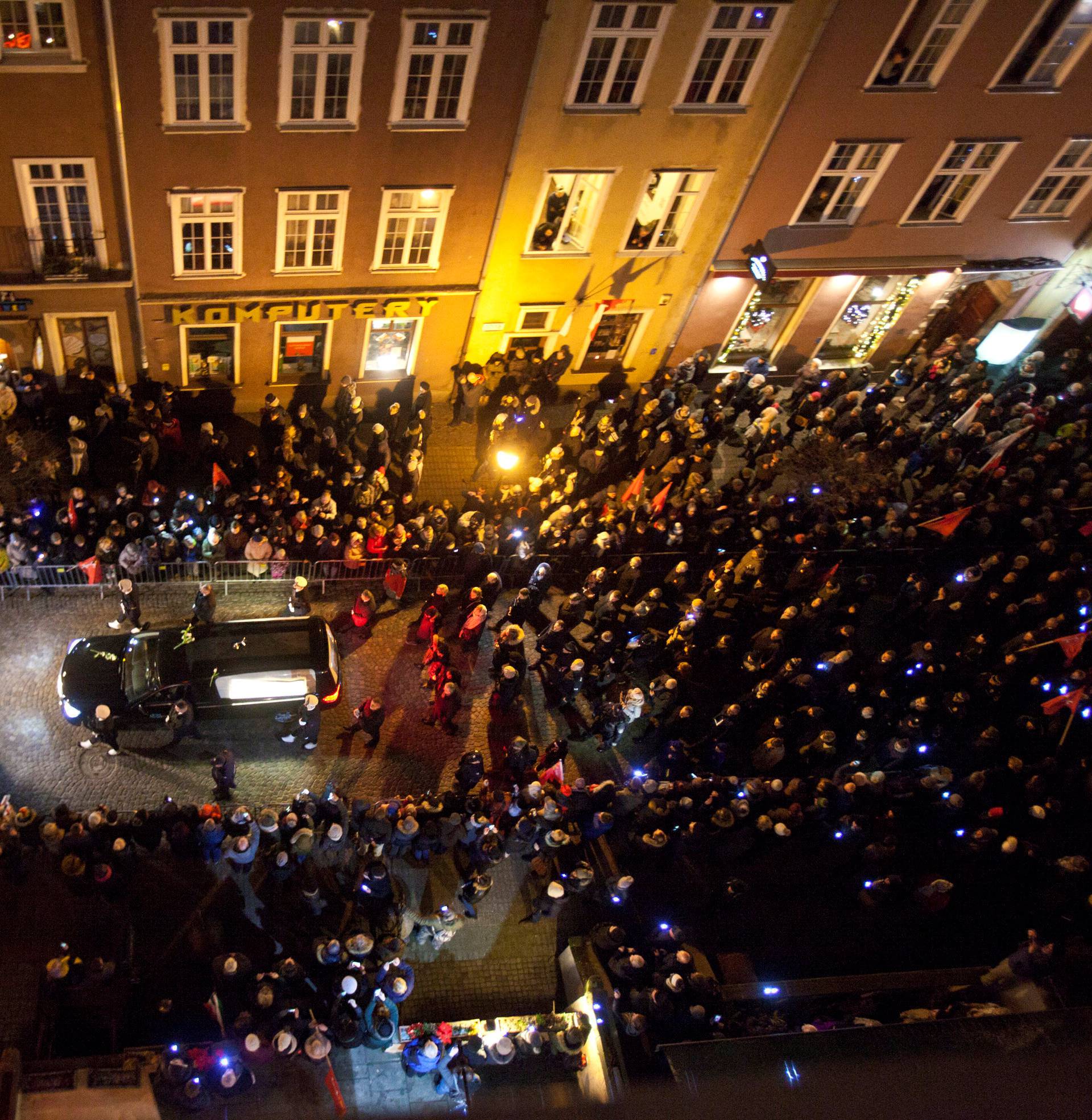People take part in a procession following the coffin of Pawel Adamowicz, Gdansk mayor who died after being stabbed at charity event, in Gdansk