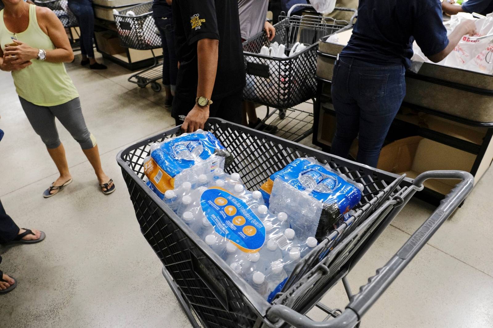 Shoppers purchase water before the arrival of Hurricane Dorian in Marsh Harbour