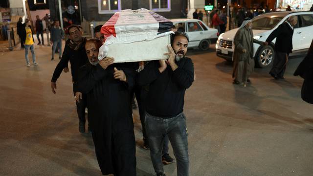 Mourners carry a coffin of a policeman who was killed in an attack in Kirkuk, during a funeral in Najaf