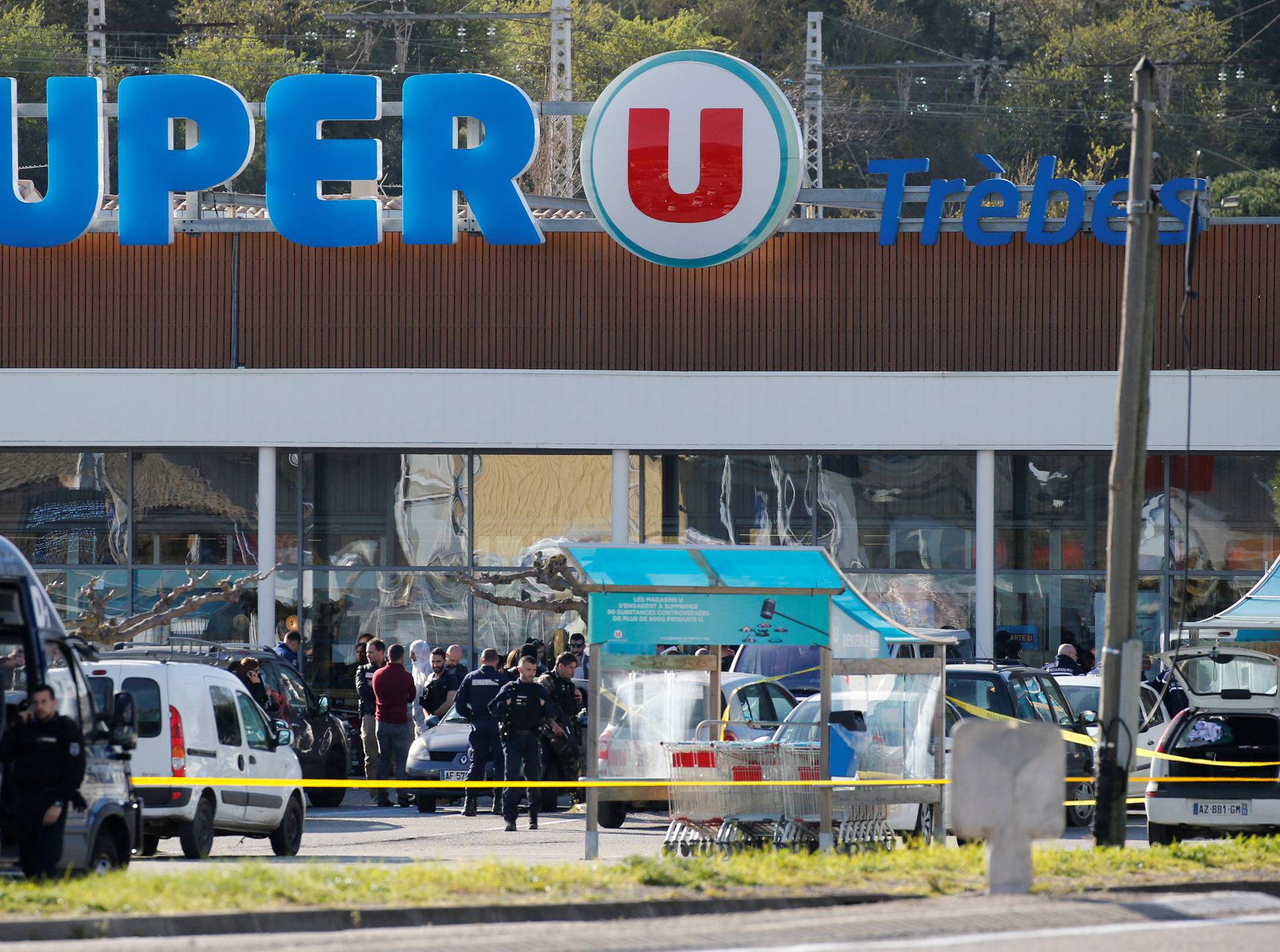 A general view shows gendarmes and police officers at a supermarket after a hostage situation in Trebes