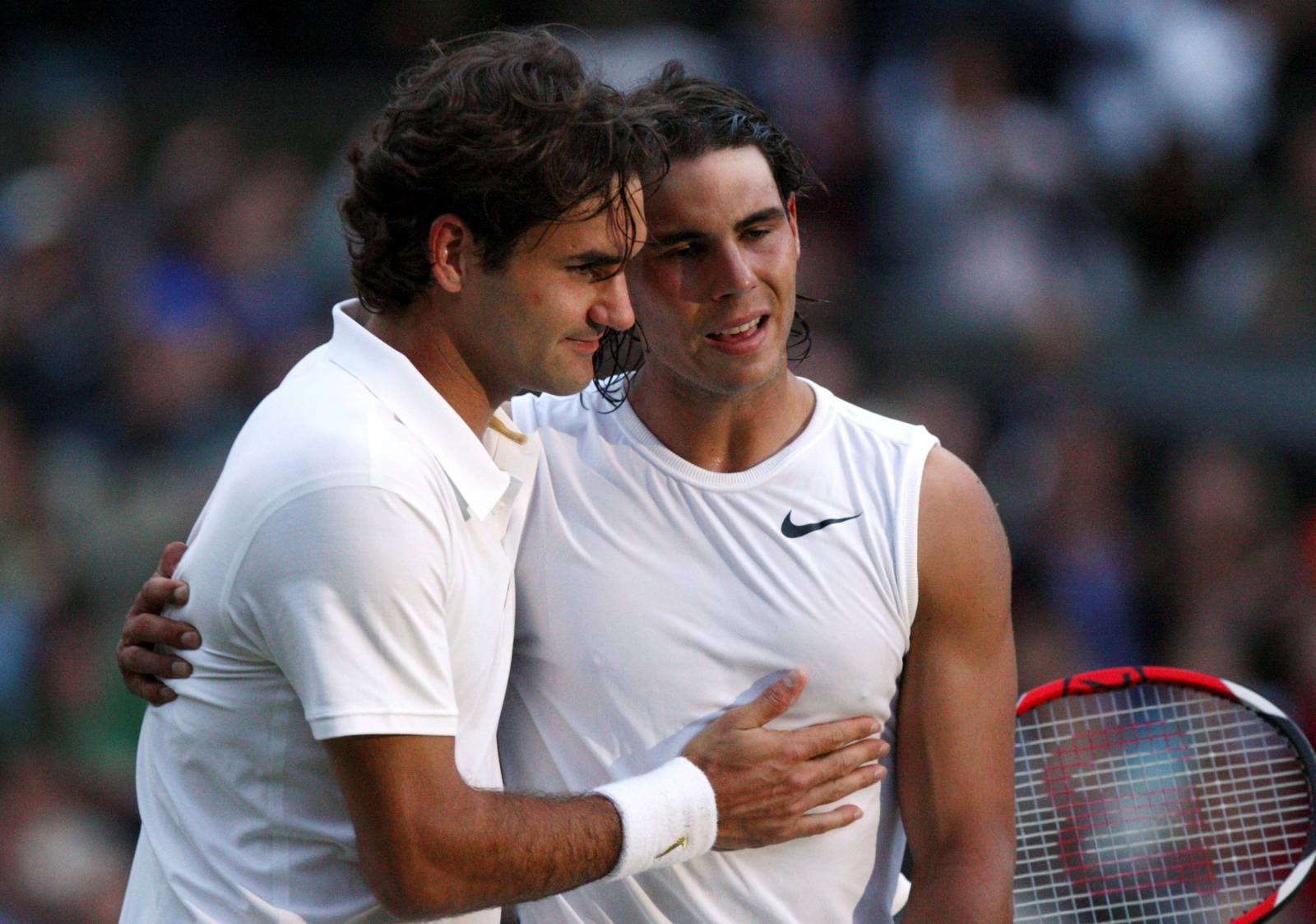 FILE PHOTO: Rafael Nadal is embraced by Roger Federer after defeating him in their finals match at the Wimbledon tennis championships in London