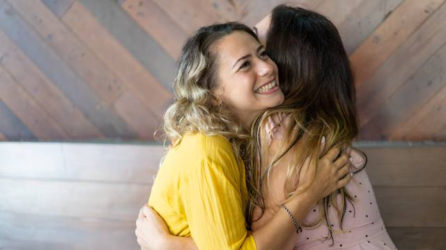 Pretty blond woman excited to see her long-distance friend