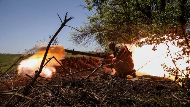 A Ukrainian service member fires an anti-tank grenade launcher at a front line near the city of Bakhmut