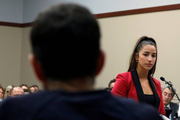 Victim and Olympic gold medalist Aly Raisman speaks at the sentencing hearing for Larry Nassar, (R) a former team USA Gymnastics doctor who pleaded guilty in November 2017 to sexual assault charges, in Lansing
