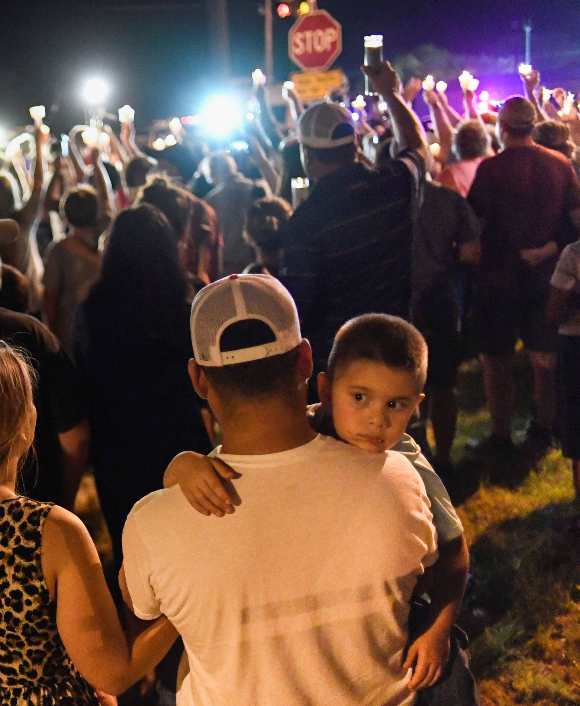 Local residents embrace during a candlelight vigil for victims of a mass shooting in a church in Sutherland Springs, Texas