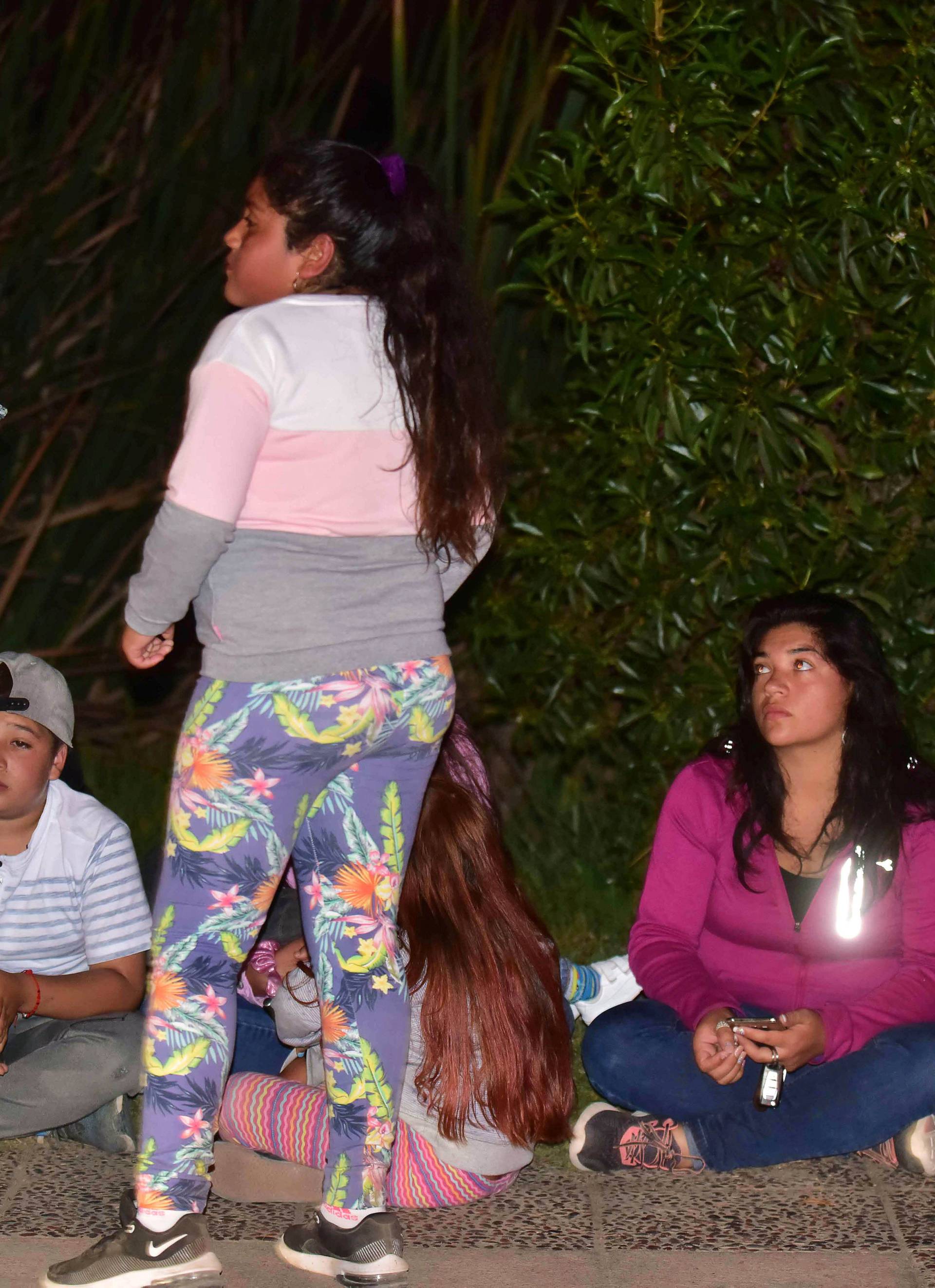 People outside their houses are seen along a street after an earthquake in Coquimbo