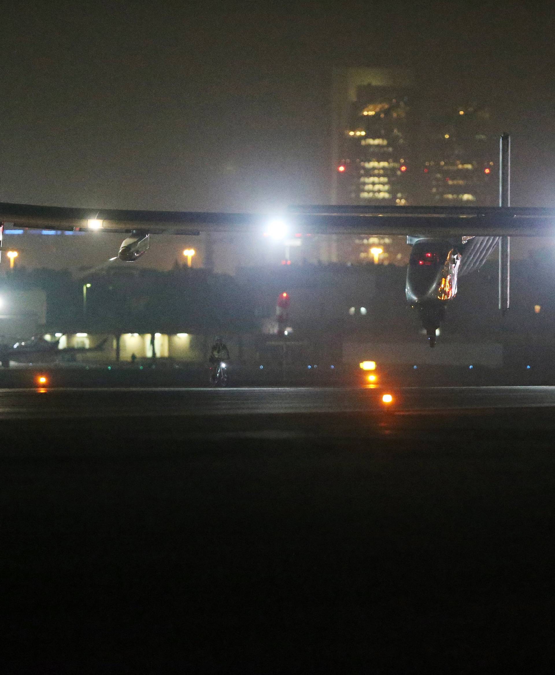 Solar Impulse 2, a solar powered plane, lands at an airport in Abu Dhabi, UAE