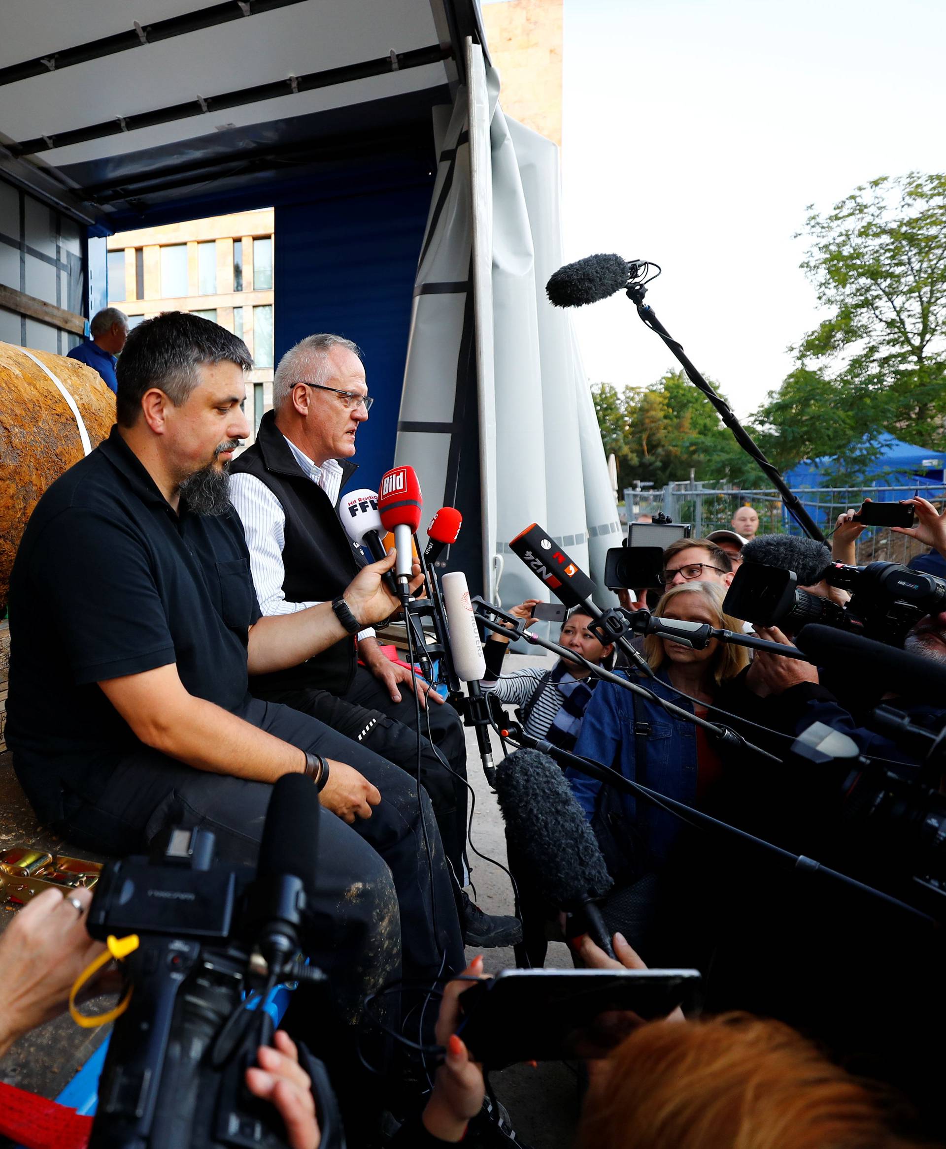 Bomb disposal experts Rene Bennert and Dieter Schweizler speak to journalits next to defused massive World War Two bomb after tens of thousands of people evacuated their homes in Frankfurt,