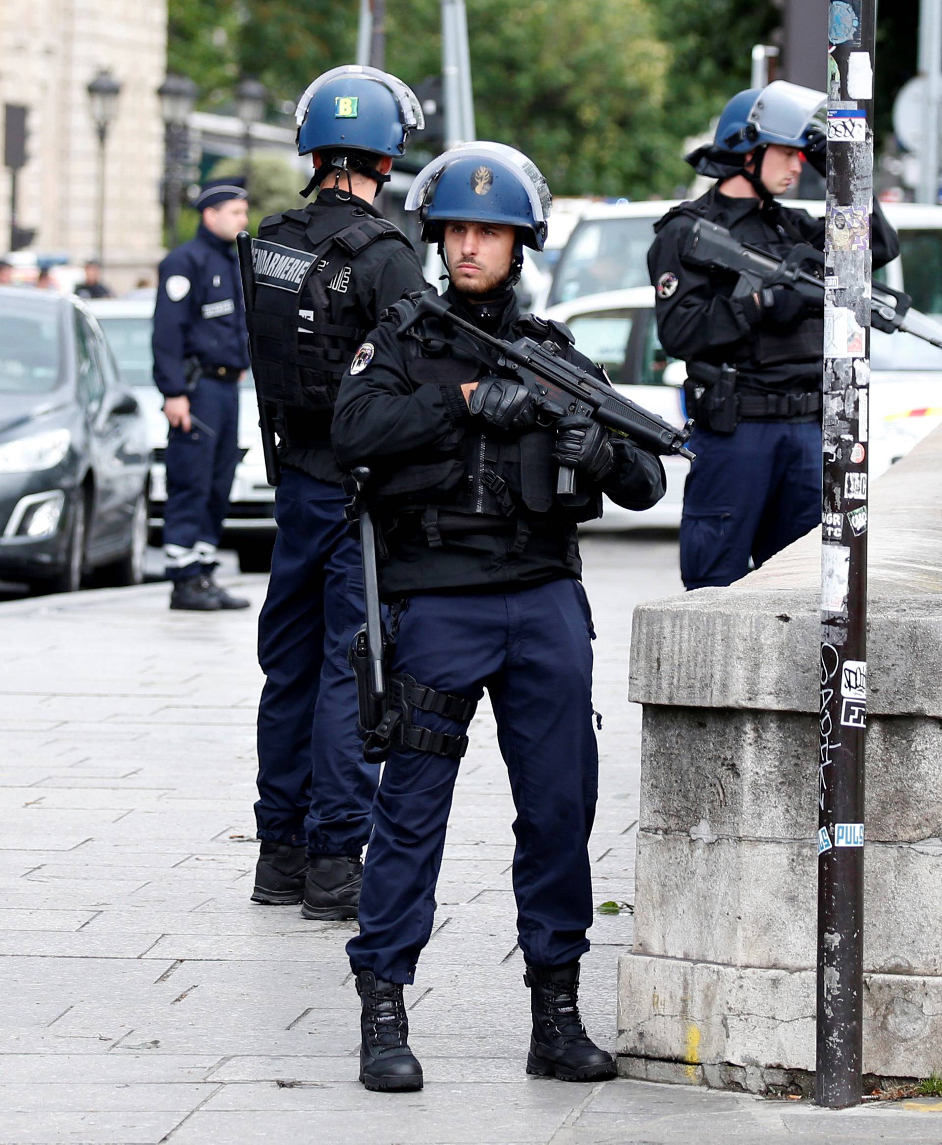 French gendarmes and police stand at the scene of a shooting incident near the Notre Dame Cathedral in Paris