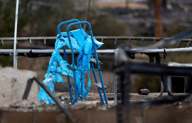 A melted playground slide as the Hawk Fire burns in Reno