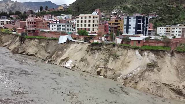 Homes teetering on edge of collapse after torrential rains in Bolivia