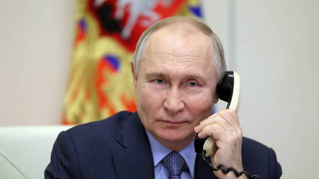 Russia's President Putin speaks on phone at his residence outside Moscow