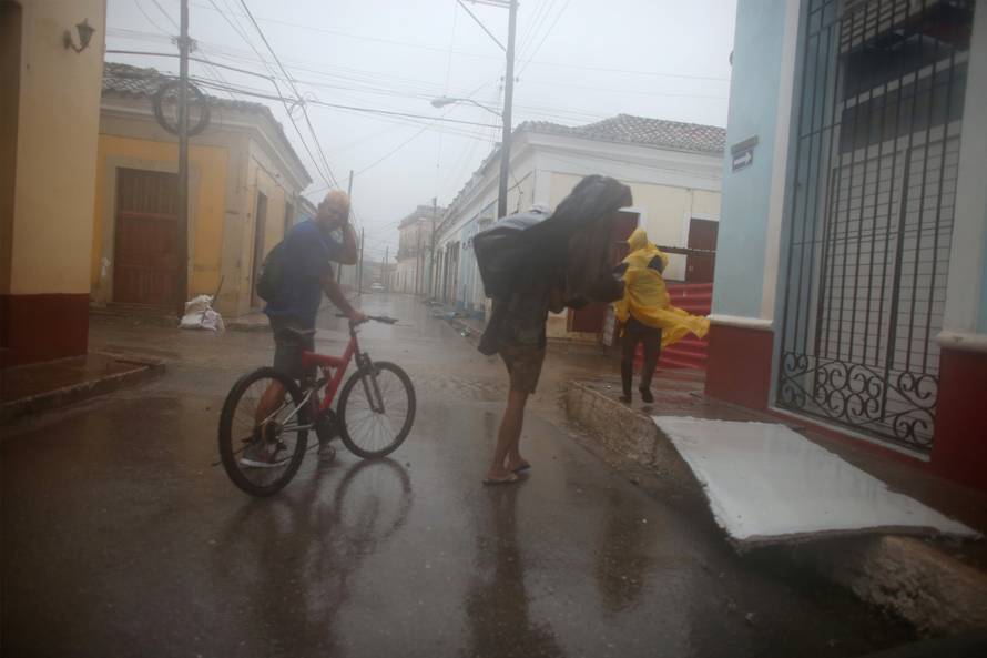 People walk on the street as Hurricane Irma passes by Remedios