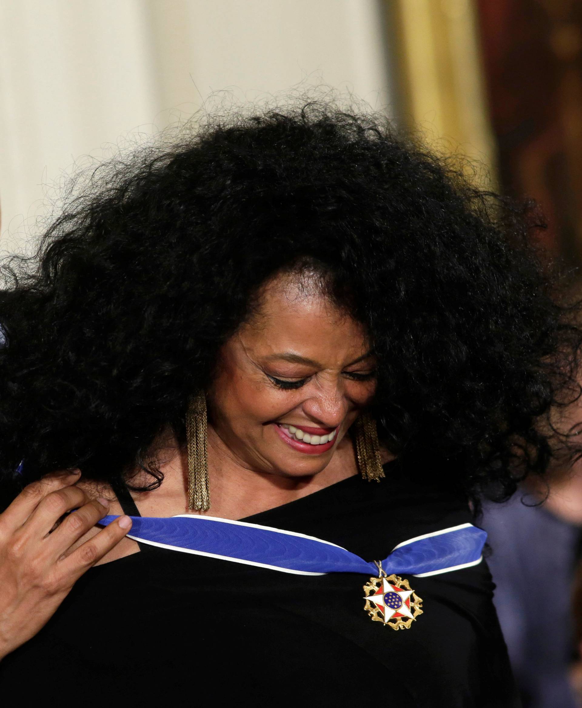 U.S. President Barack Obama presents the Presidential Medal of Freedom to singer Diana Ross during a ceremony in the White House East Room in Washington