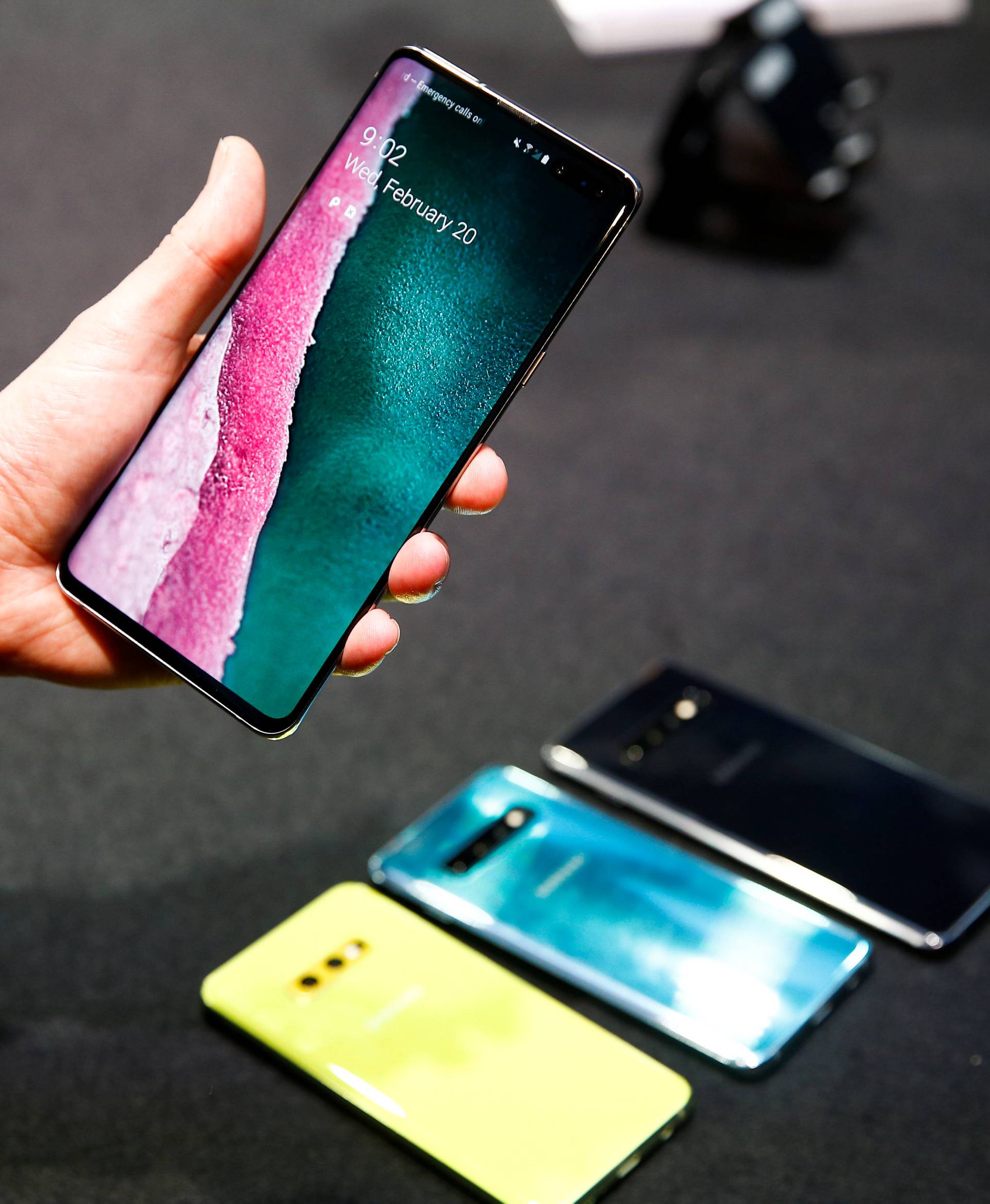 A journalist holds the new Samsung Galaxy S10 smartphone at a press event in London