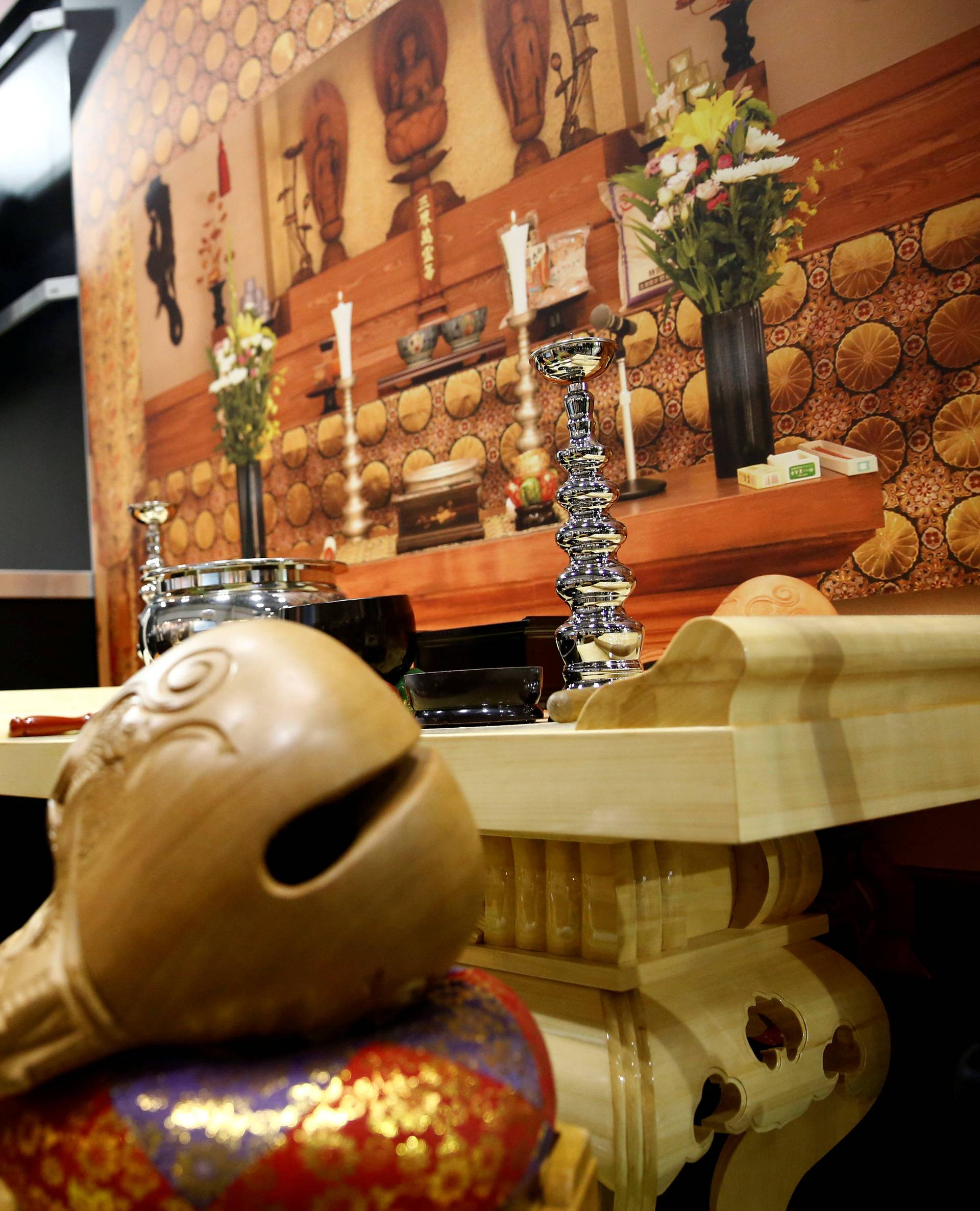 A 'robot priest' wearing a Buddhist robe stands in front of a funeral altar during its demonstration at Life Ending Industry EXPO 2017 in Tokyo