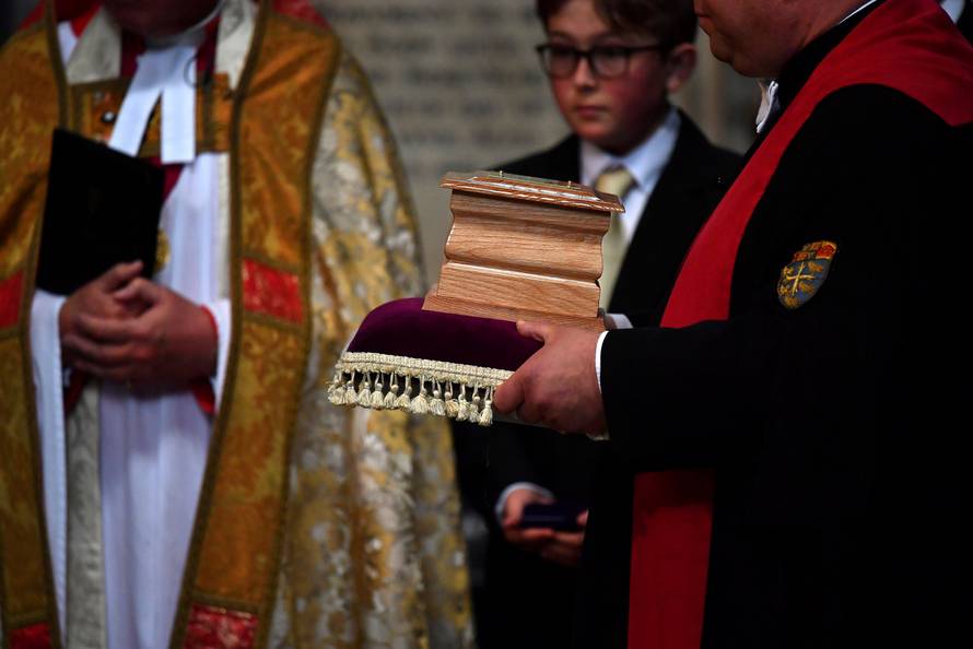 The ashes of British scientist Stephen Hawking are held at the site of interment in the nave of the Abbey church, during a memorial service at Westminster Abbey, in London