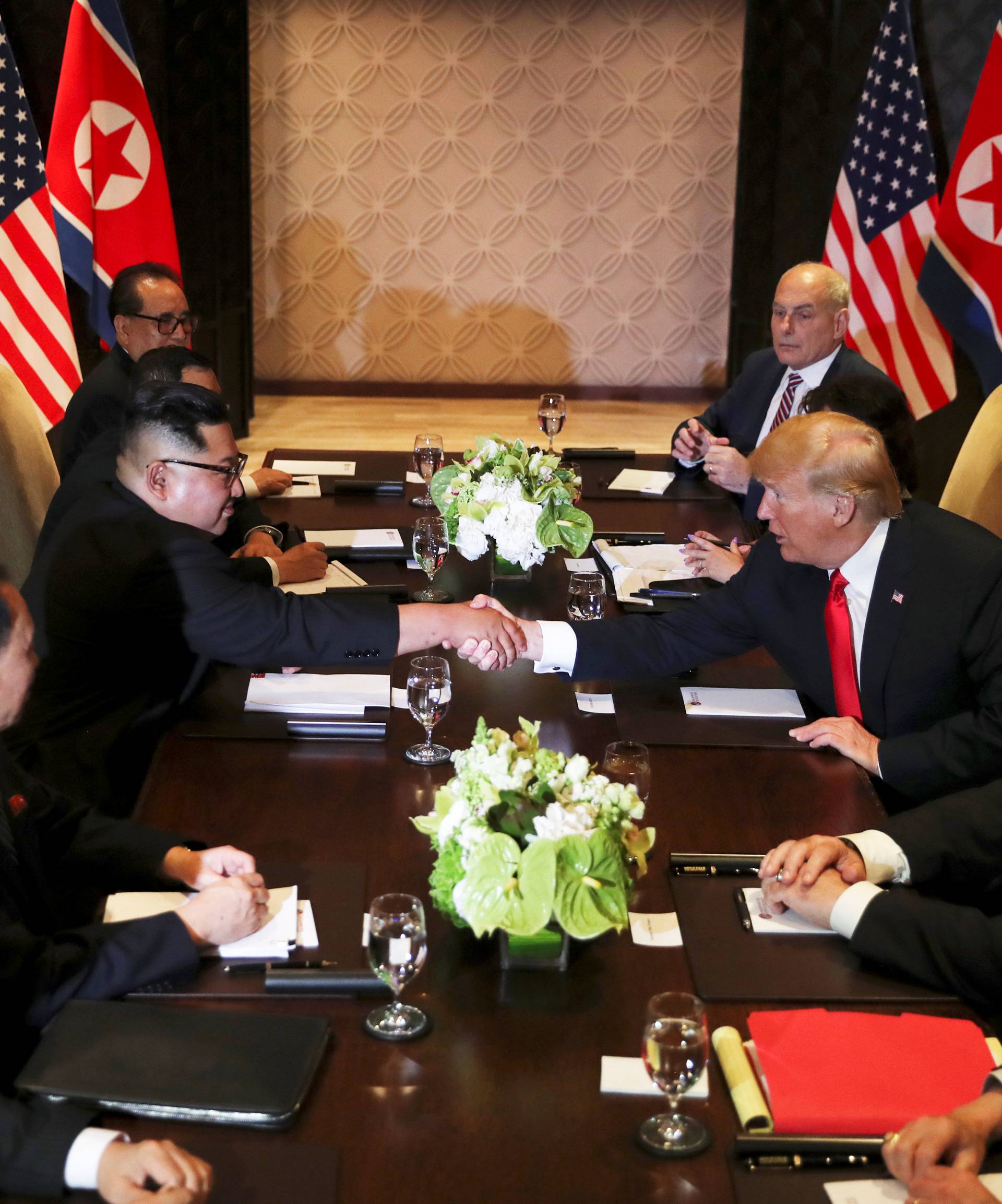 U.S. President Donald Trump shakes hands with North Korea's leader Kim Jong Un before their meeting in Singapore