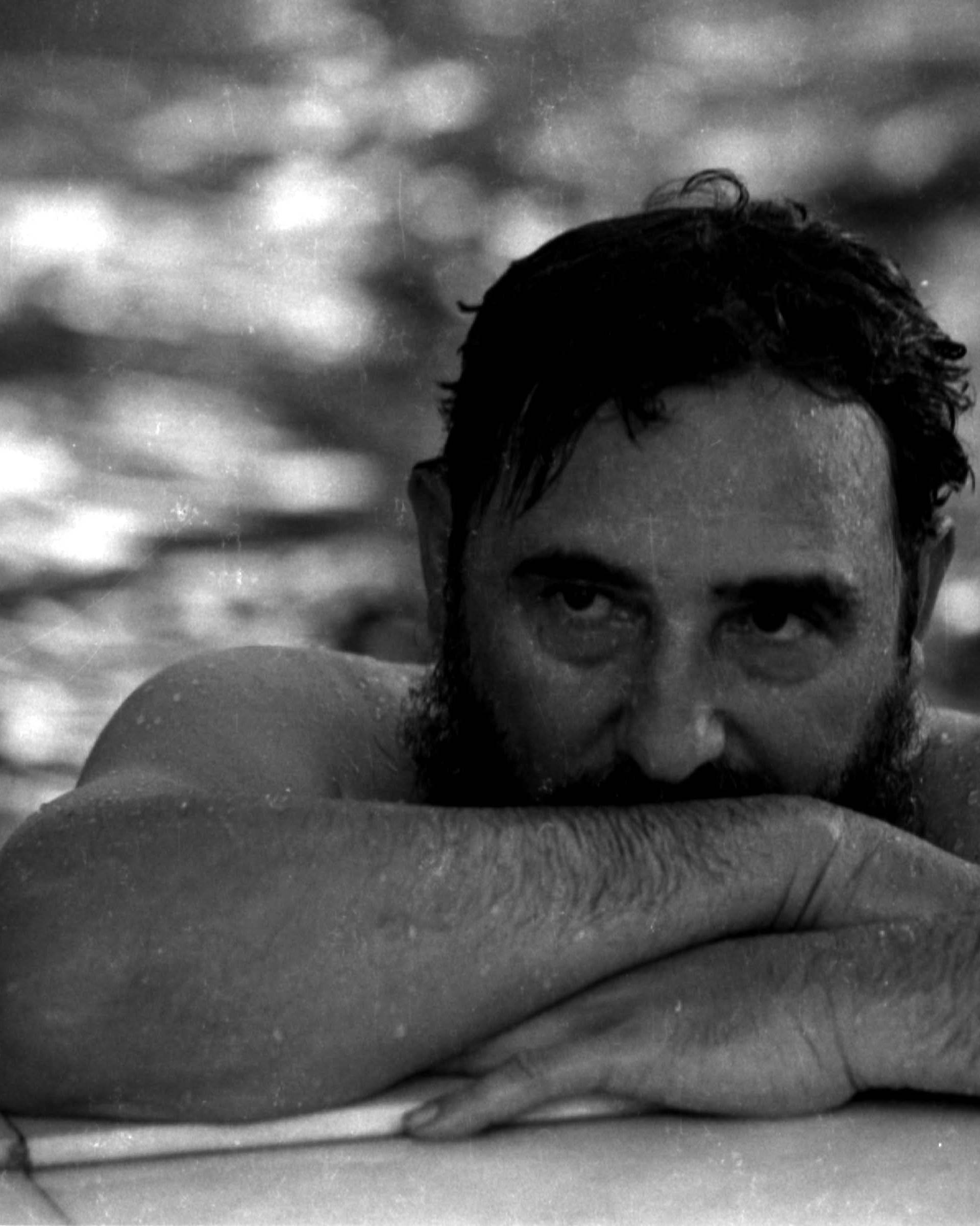File photo of then Cuban Prime Minister Fidel Castro relaxing in a swimming pool during a visit to Romania