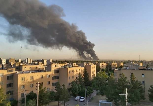 Smoke rises at an oil refinery in Tehran