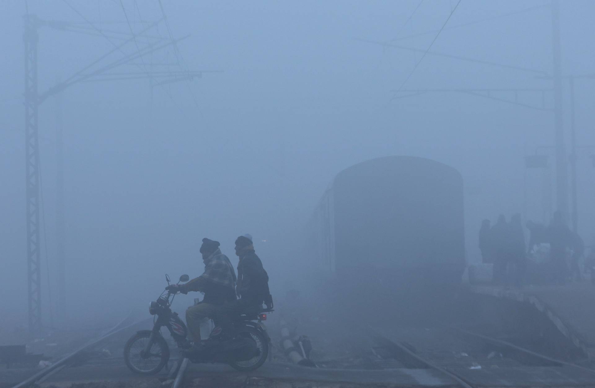 Railway tracks amidst heavy fog on a cold winter morning in New Delhi