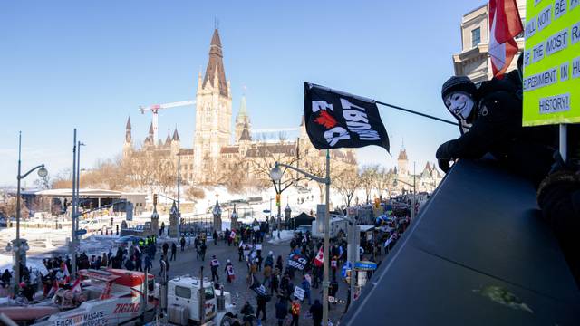 Protestors gather in front of Parliament Hill as truckers and supporters take part in a convoy to protest against COVID-19 vaccine mandate in Ottawa