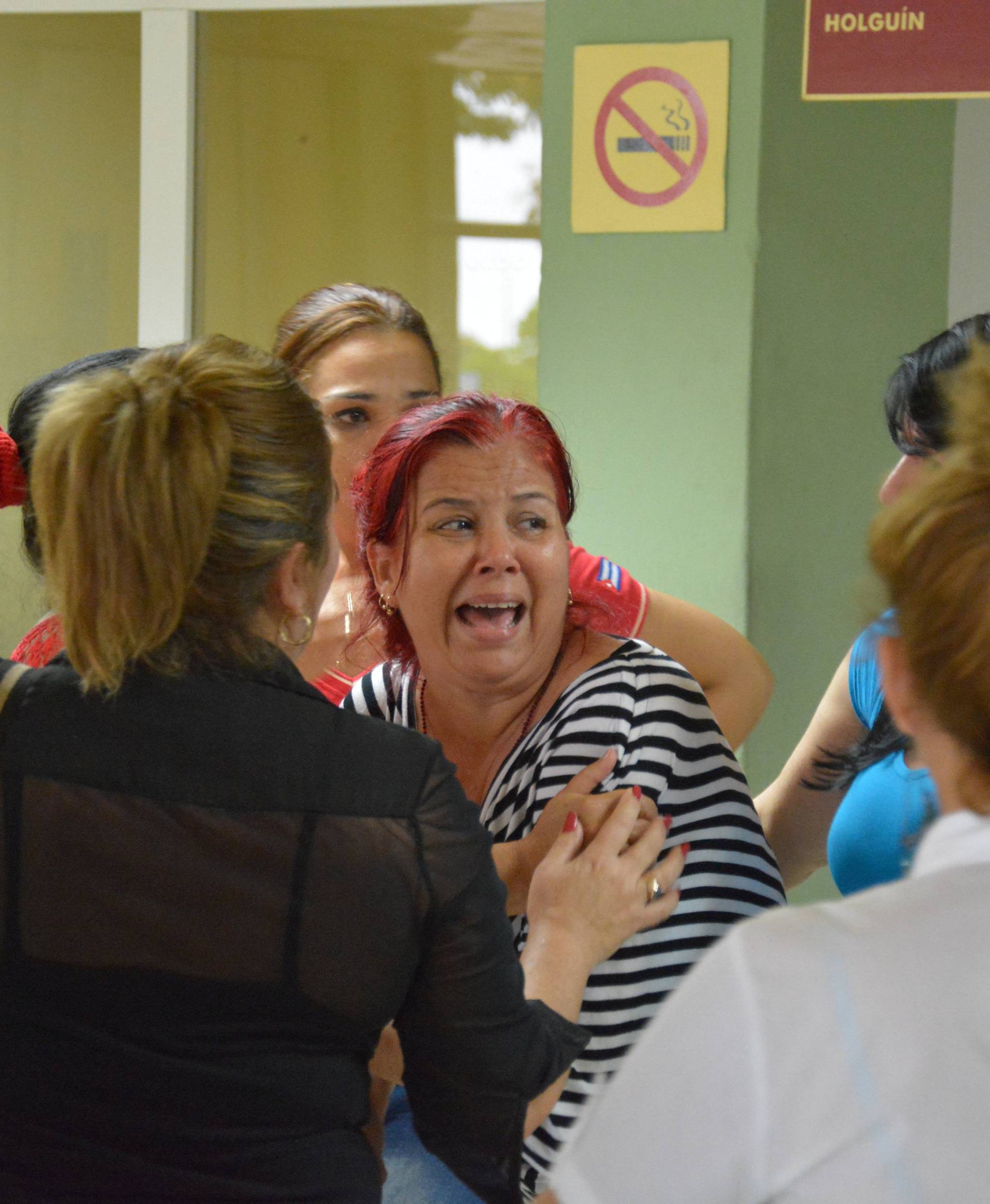 Relatives of passengers traveling on the Boeing 737 plane that crashed shortly after taking off from Havana's main airport react at Franck Pais airport in Holguin