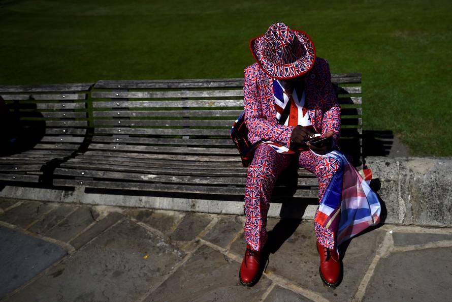 A man wears a Union flag themed suit outside Windsor Castle ahead of Britain's Prince Harry's wedding to Meghan Markle in Windsor