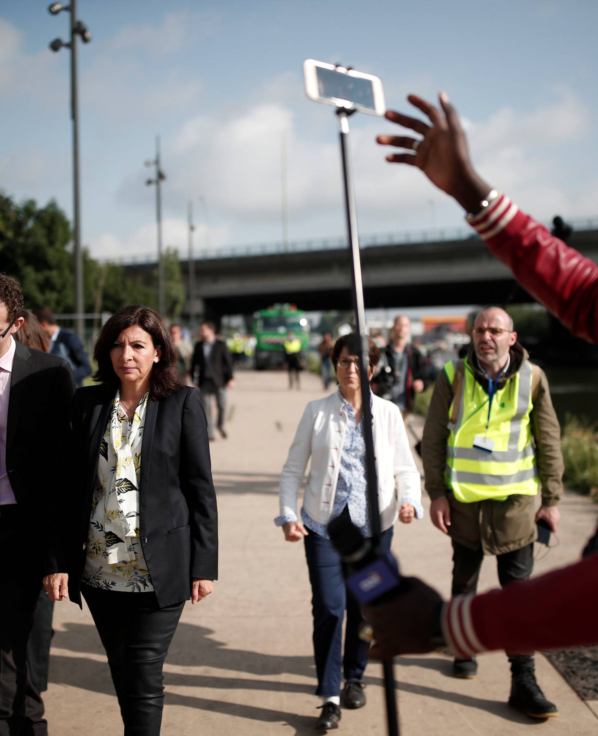 Paris city mayor Anne Hidalgo visits the site after French police evacuated hundreds of migrants living in makeshift camps along a canal in Paris