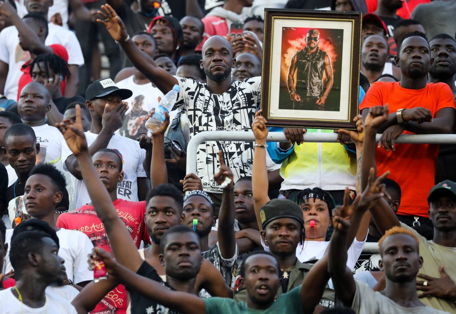 Fans react during a tribute ceremony for DJ Arafat in Abidjan
