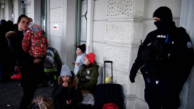 People wait at the train station after fleeing Russian invasion of Ukraine