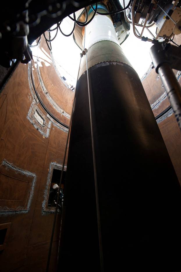 FILE PHOTO: A Minuteman III missile booster is lowered into the tube at Launch Facility during emplacement for Glory Trip-215 at Vandenberg Air Force Base
