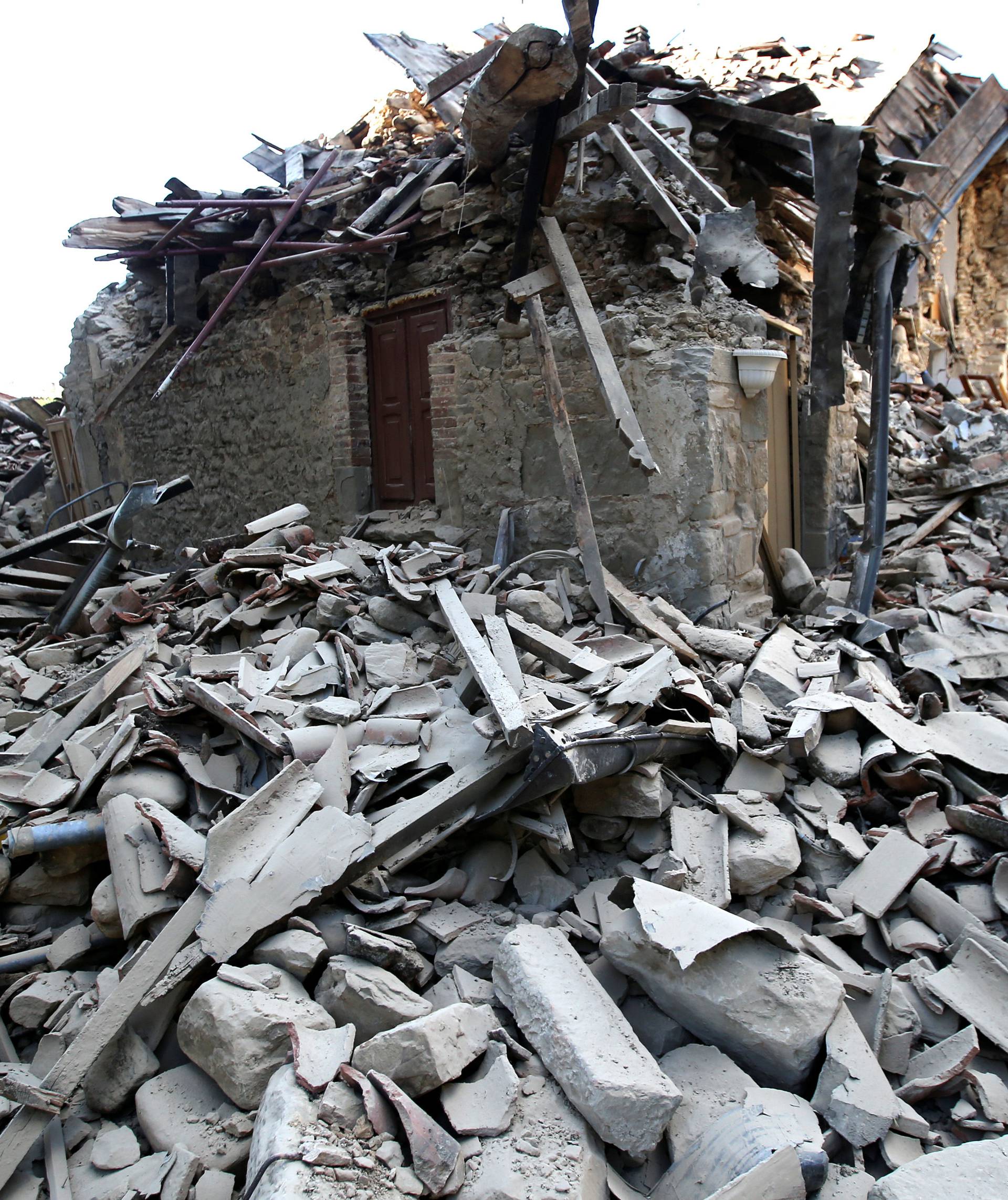 A collapsed house is seen following an earthquake in Amatrice