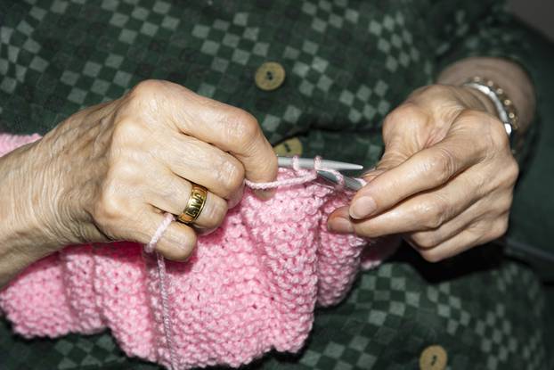 Old woman Knitting at home.