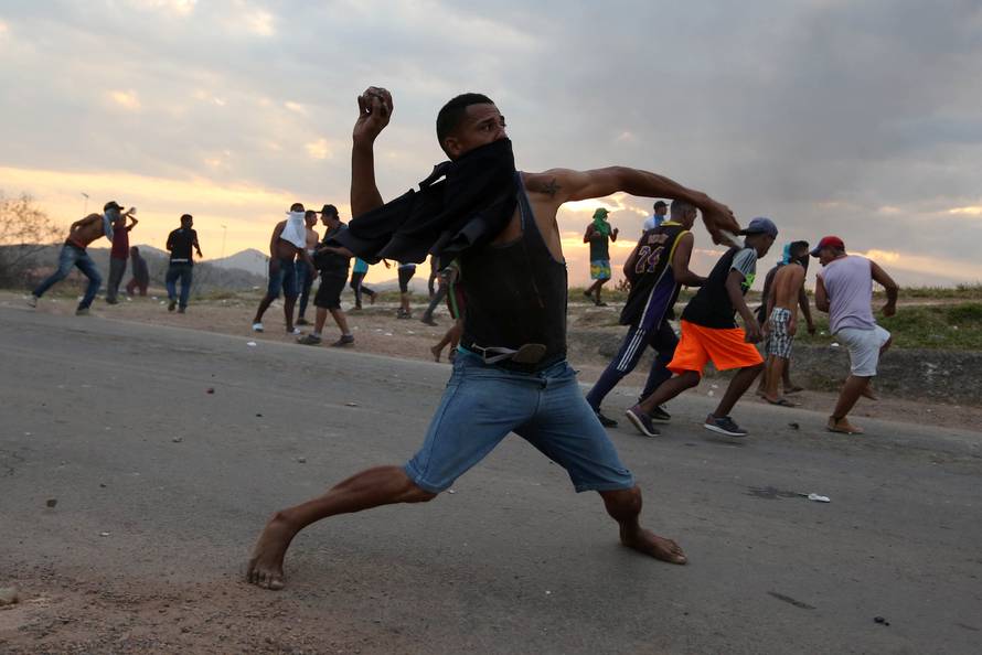 People hurl stones at the border between Venezuela and Brazil in Pacaraima