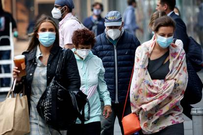 People wear protective face masks as haze and smoke  from Canadian wildfires continues to linger in New York