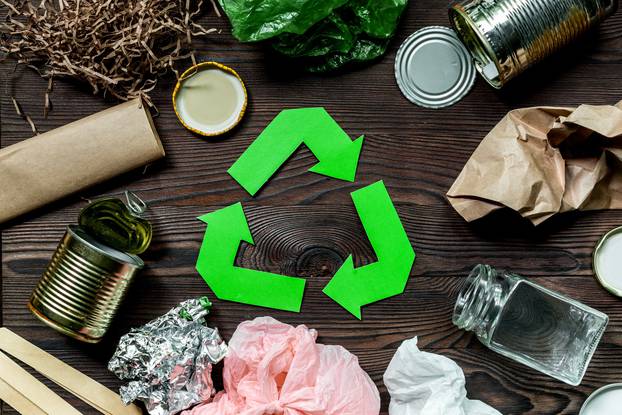 Eco concept with recycling symbol on wooden table background top view