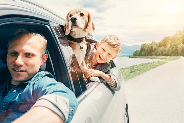 Father,With,Son,And,Dog,Look,From,The,Car,Window