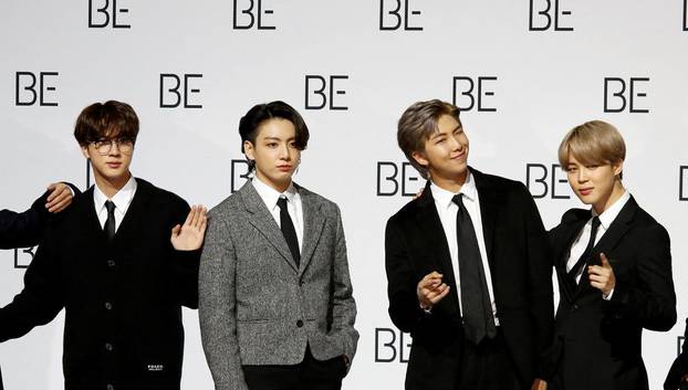 FILE PHOTO: Members of K-pop boy band BTS pose for photographs during a news conference promoting their new album "BE(Deluxe Edition)" in Seoul